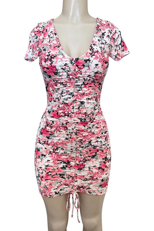 pink floral patterned dress on a mannequin against a white background