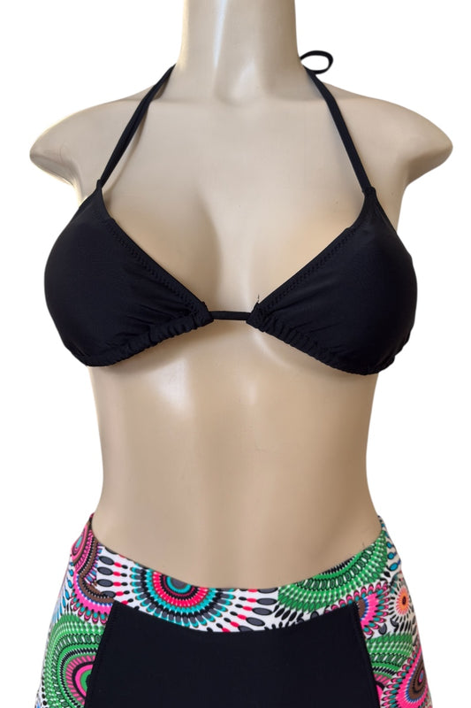 Black bikini top on a mannequin with a colorful patterned bottom.