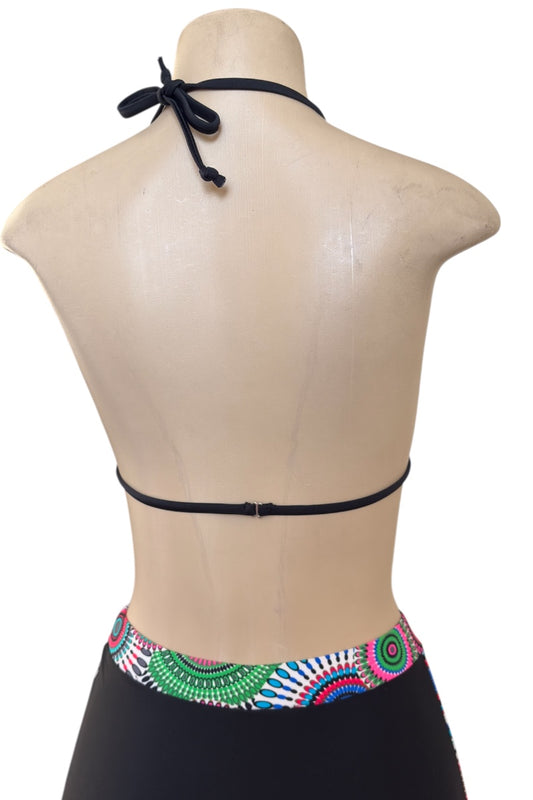 Black bikini top with colorful bottom on a mannequin against a white background
