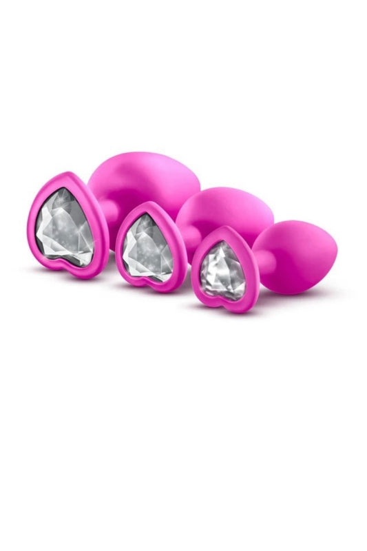 Pink silicone butt plugs with clear gemstones on a white background