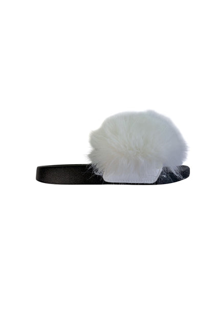 A single black slide sandal featuring a large, fluffy white faux fur pom-pom on a slide, shown against a plain white background.