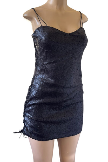 Black sequin dress on a mannequin against a white background