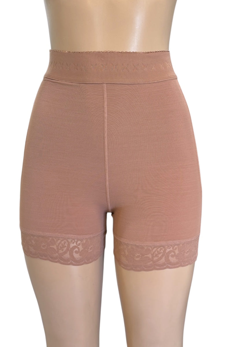 High-waisted shapewear shorts in a beige color, featuring a lace trim at the hem, displayed on a mannequin torso against a white background.