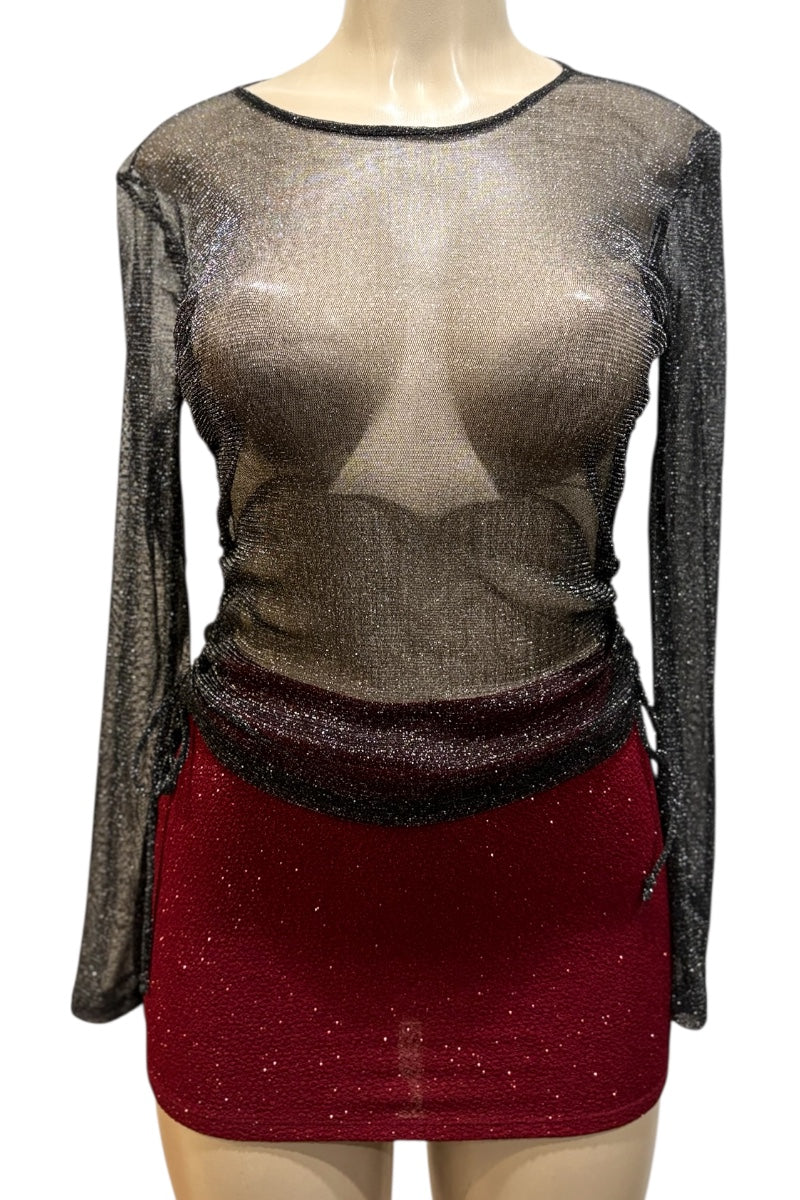 Mannequin wearing a sheer top with long sleeves and a red skirt on a white background