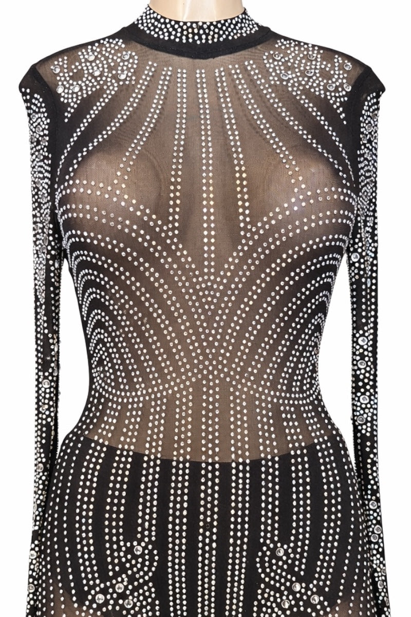 Sheer black jumpsuit with embellishments on a mannequin