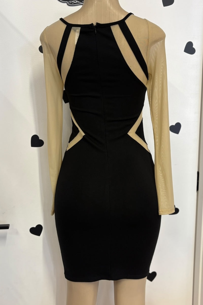 Black dress with beige mesh sleeves on a mannequin against a white background