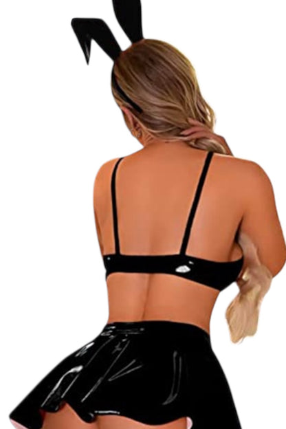 Person wearing a black bunny costume with a white background