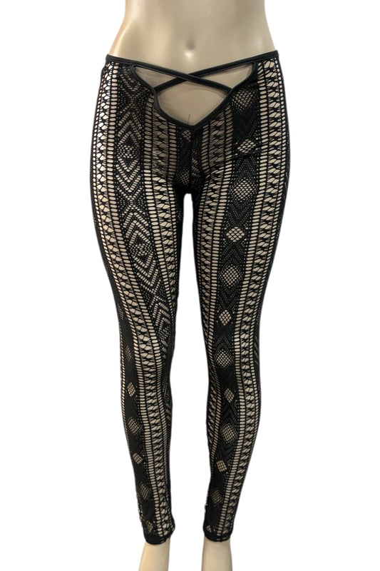 Black patterned leggings on a mannequin against a white background