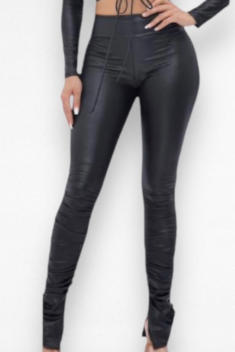 Black leather leggings worn by a person on a white background