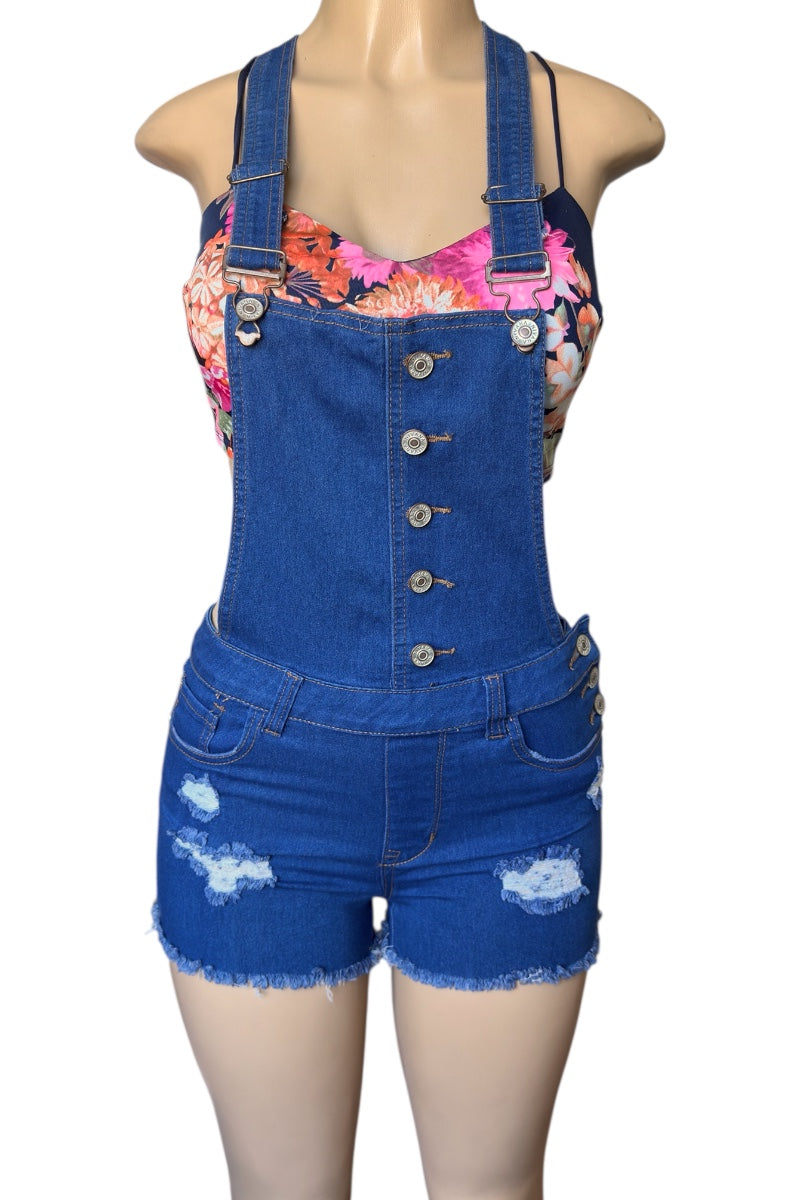 Blue denim overalls with floral top on a mannequin against a white background
