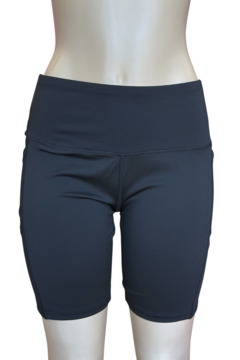 Black athletic shorts on a mannequin against a white background