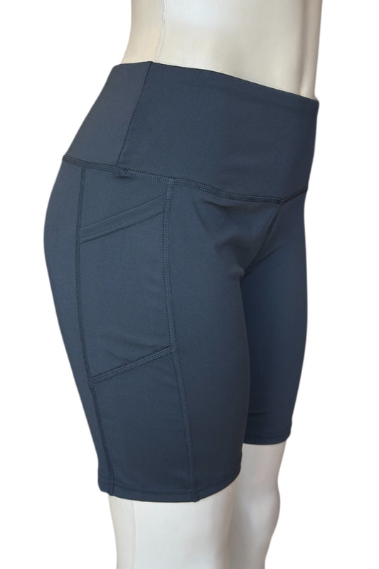 Black athletic shorts on a mannequin against a white background