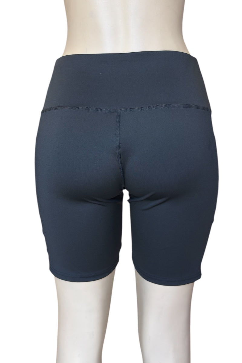 Black athletic shorts on a mannequin against a white background