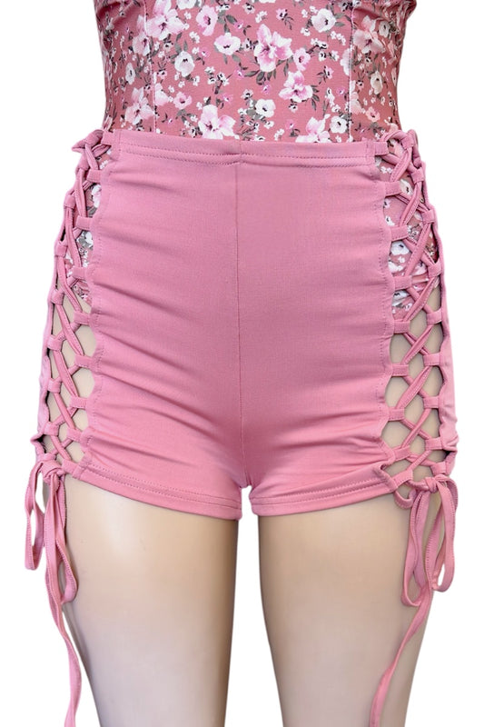 Pink shorts with lattice design on a white background