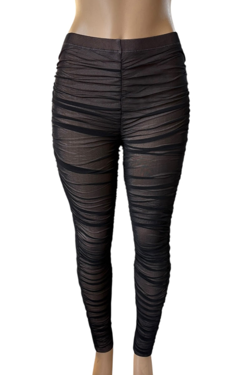 Black ruched leggings on a white background