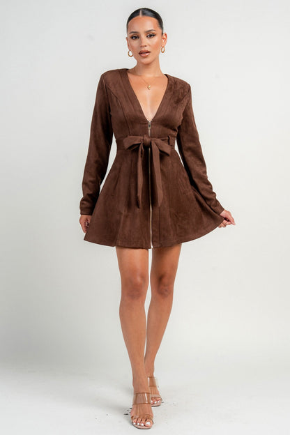 Woman wearing a brown chocolate dress with long sleeves on a white background
