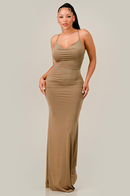 Woman wearing a beige cocoa maxi dress against a plain background
