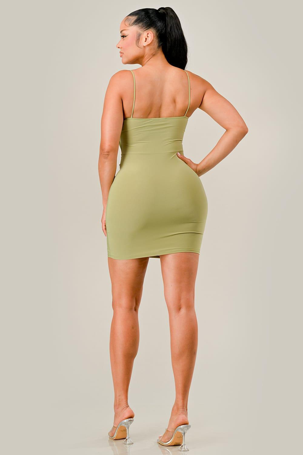 Woman wearing a green dress against a plain background
