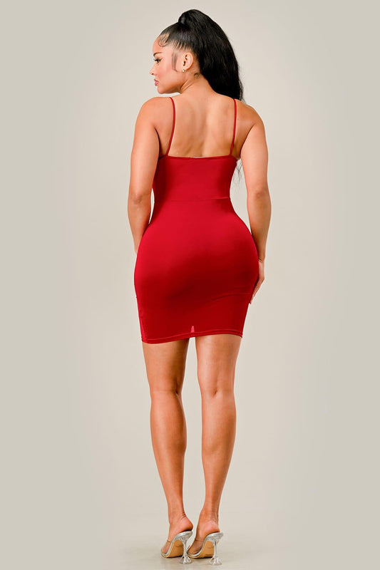 Woman wearing a red dress against a plain background