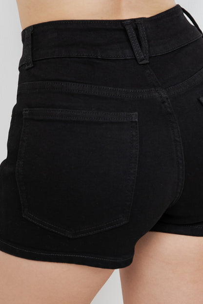 Close-up of black shorts on a plain background
