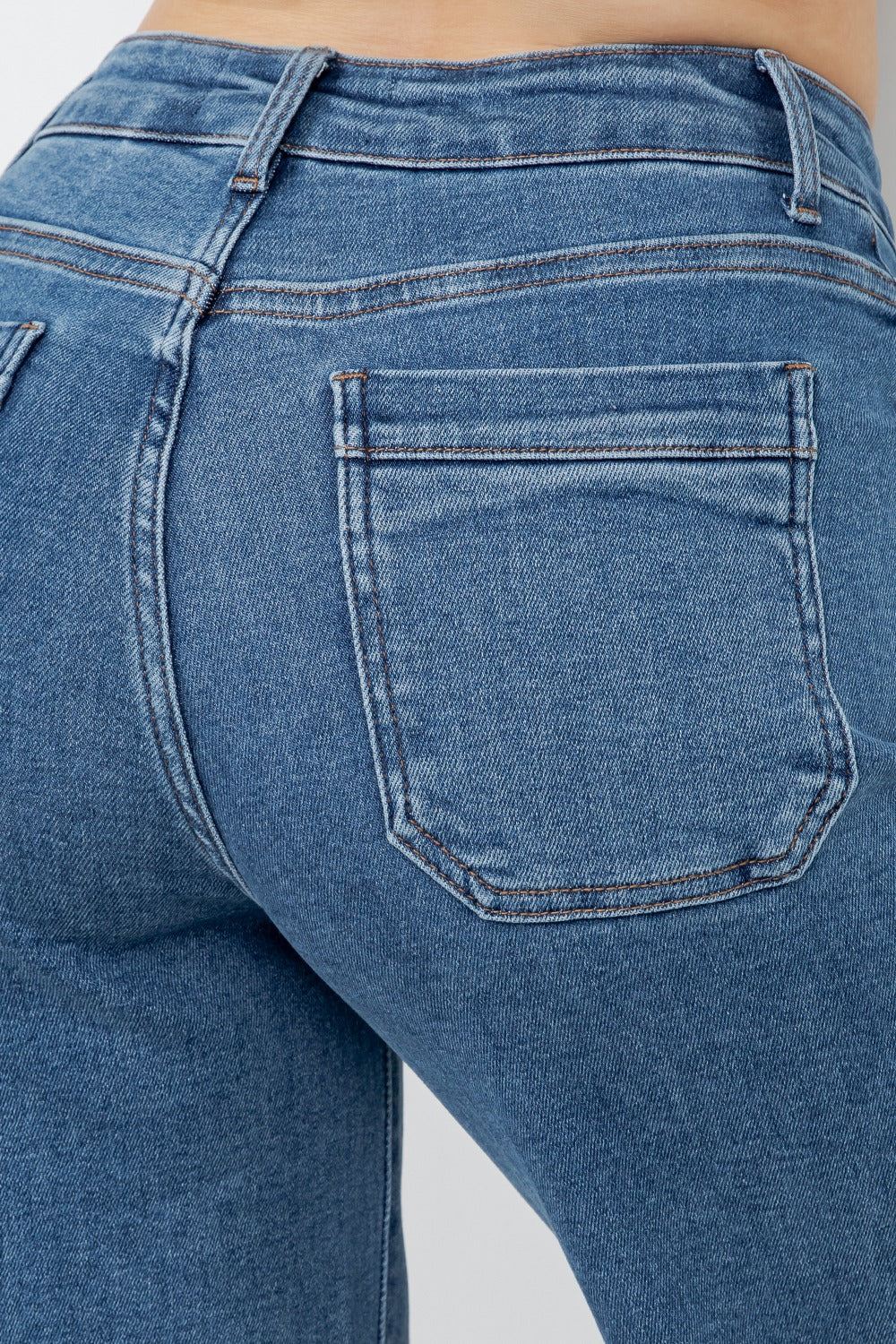 Close-up of blue jeans with a focus on the back pocket.