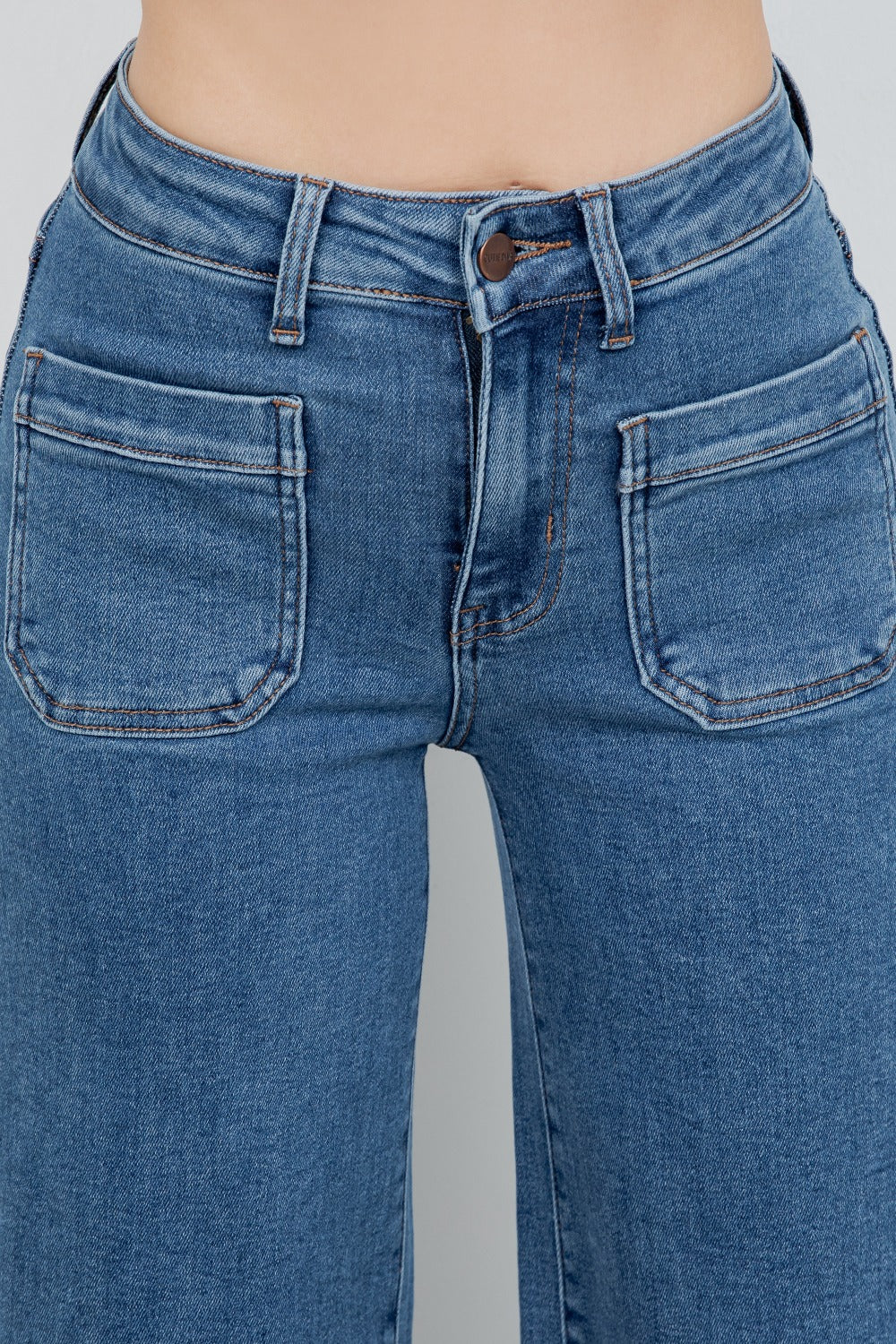 Close-up of blue jeans on a plain background