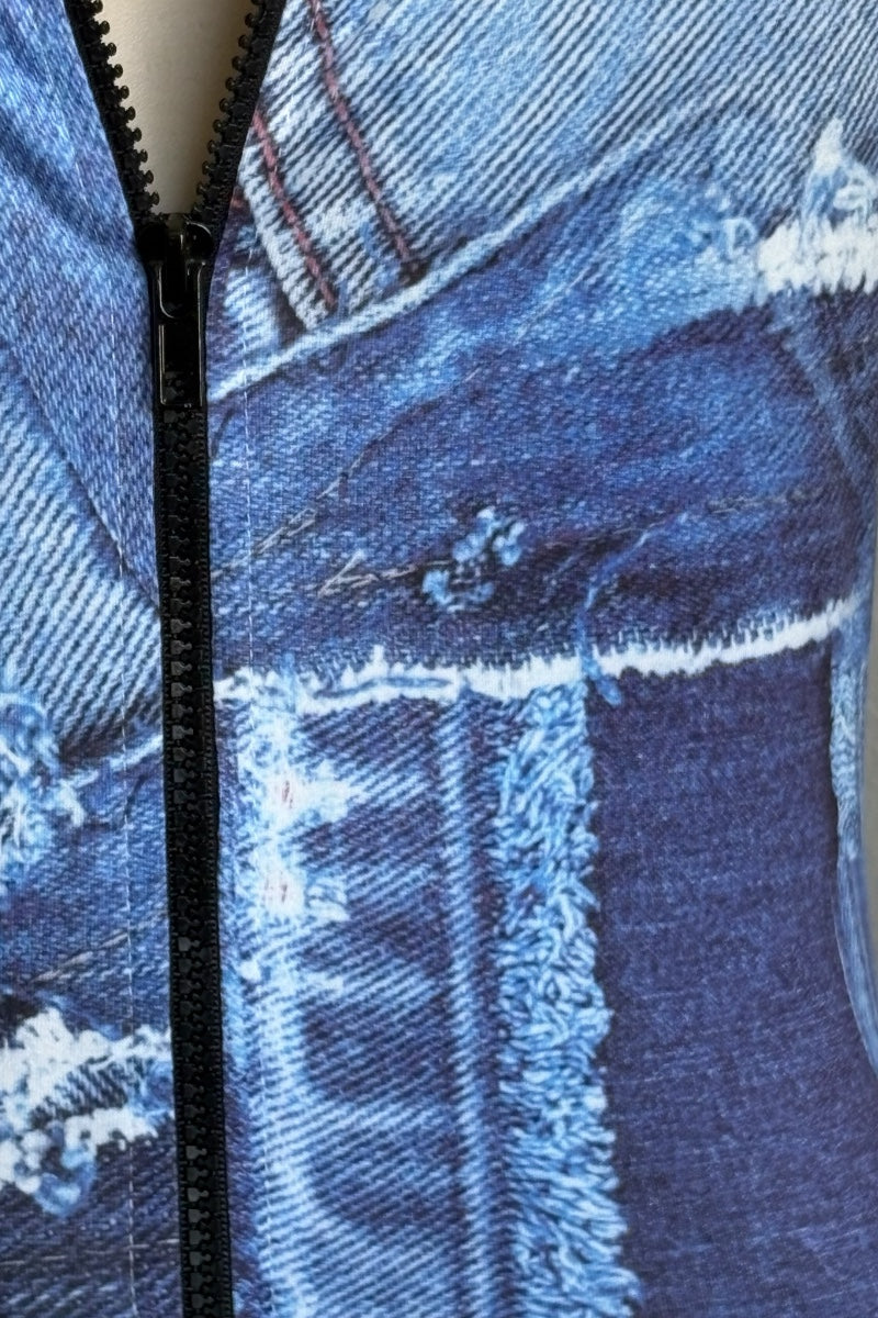 Close-up of a blue denim print romper with zipper and frayed hem details.
