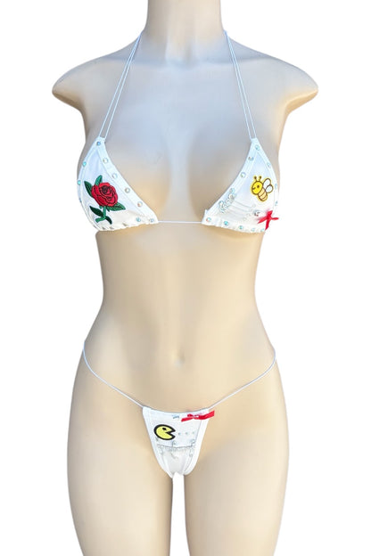 Bikini set with floral and graphic design on a mannequin against a white background