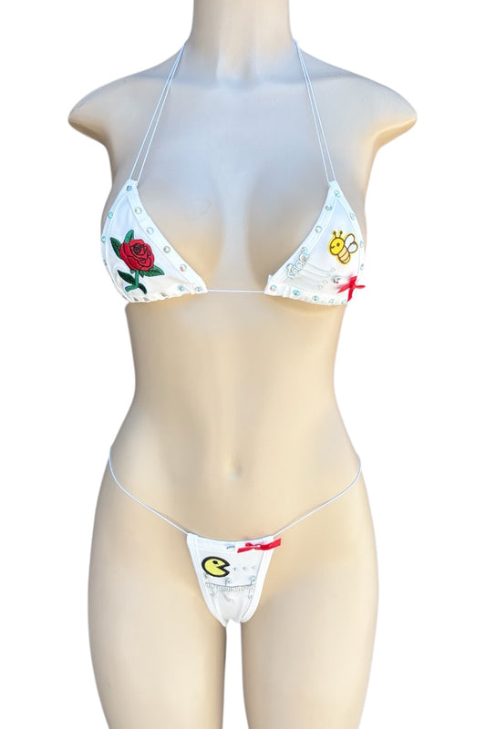 Bikini set with floral and graphic design on a mannequin against a white background