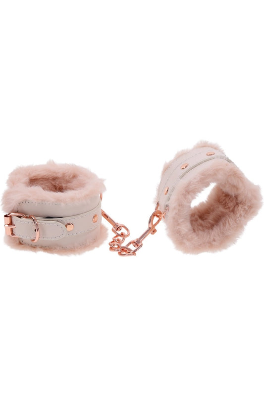 Pair of pink fluffy cuffs with a chain on a white background