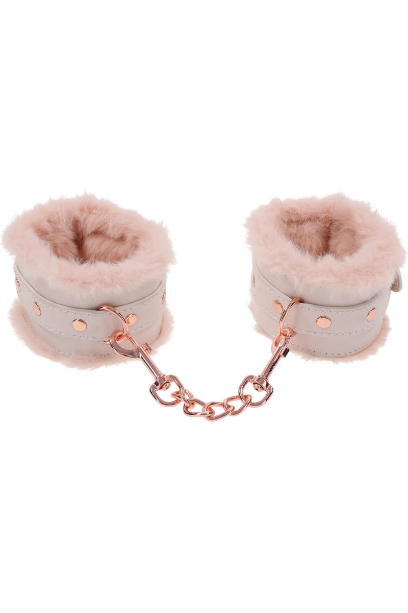 Pair of pink fluffy cuffs with a chain on a white background