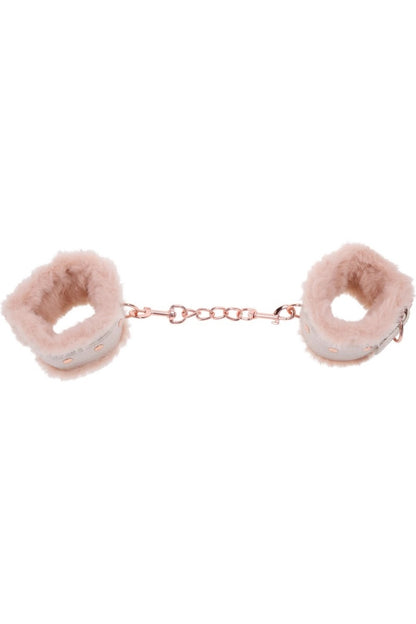 Pink fluffy handcuffs on a white background