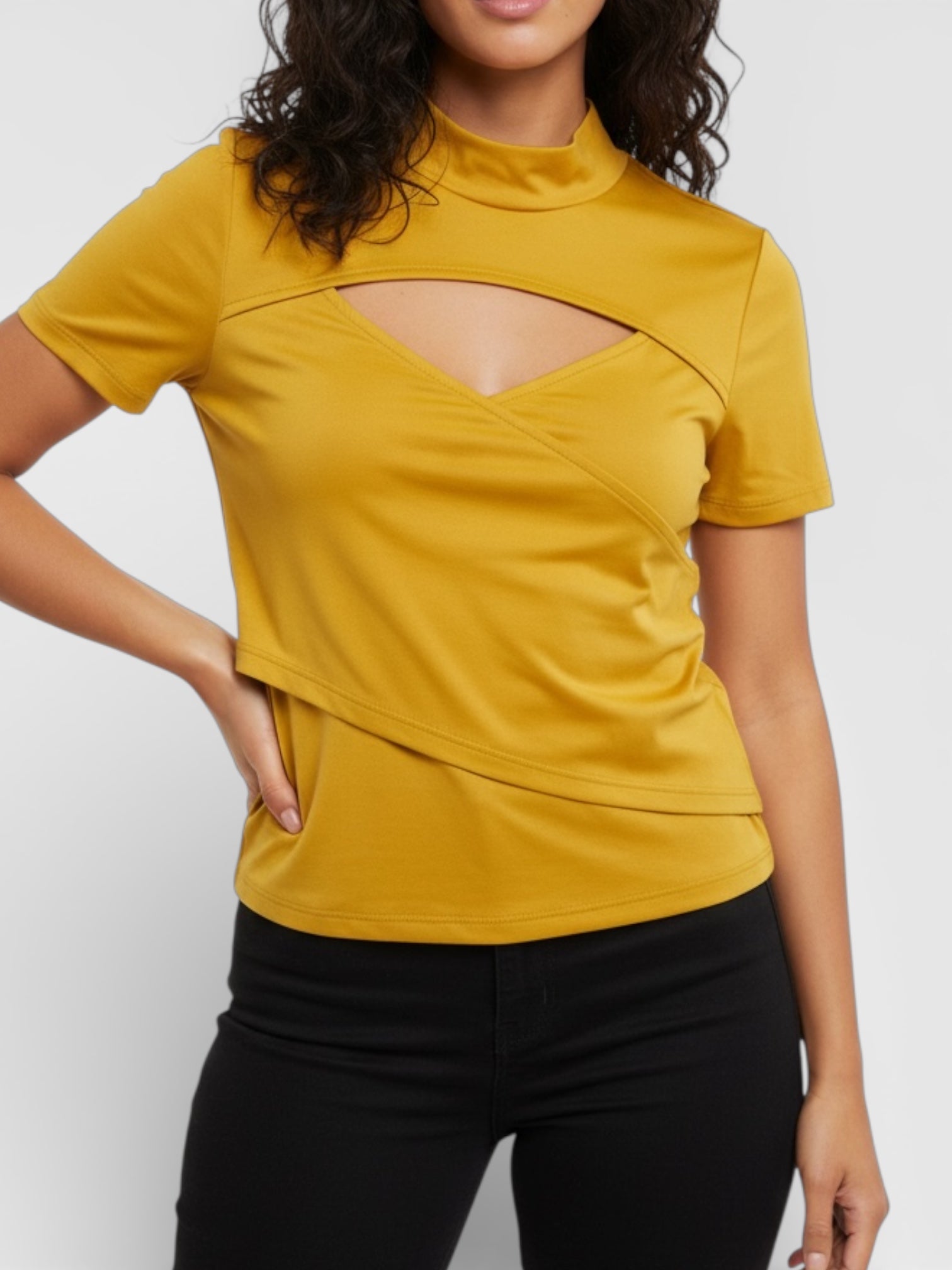 Yellow top with cut-out design worn by a person on a white background