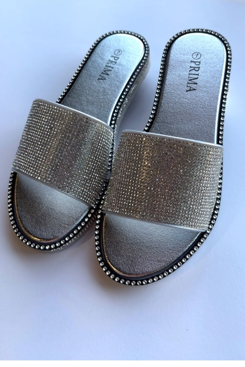 Silver embellished sandals on a white background