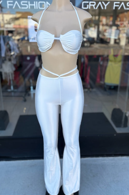 Mannequin wearing an off white outfit with sheer top in a store setting