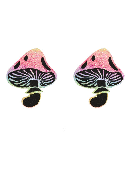 Mushroom-shaped pasties with pink caps and black stems on a white background