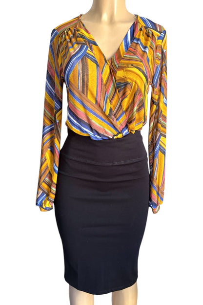 Mannequin wearing a colorful patterned top and black skirt on a white background