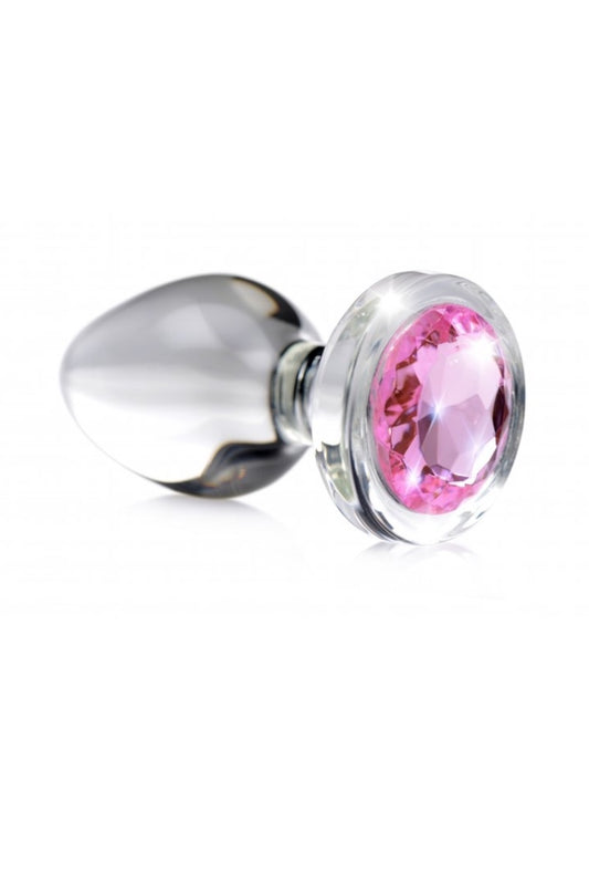 Metallic plug with a pink gem on a white background