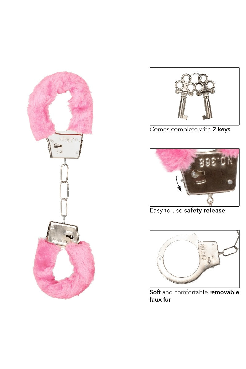 Pink fluffy handcuffs with keys on a white background