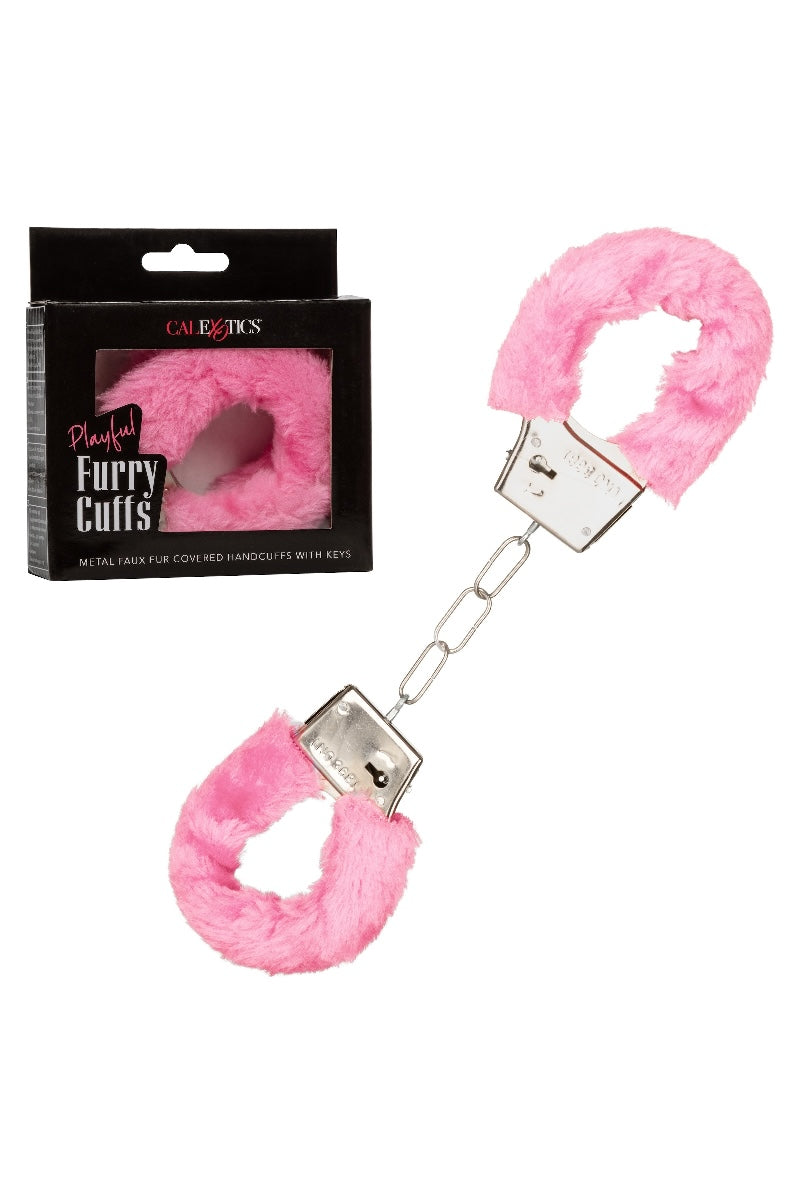 Pink fluffy handcuffs with packaging on a white background