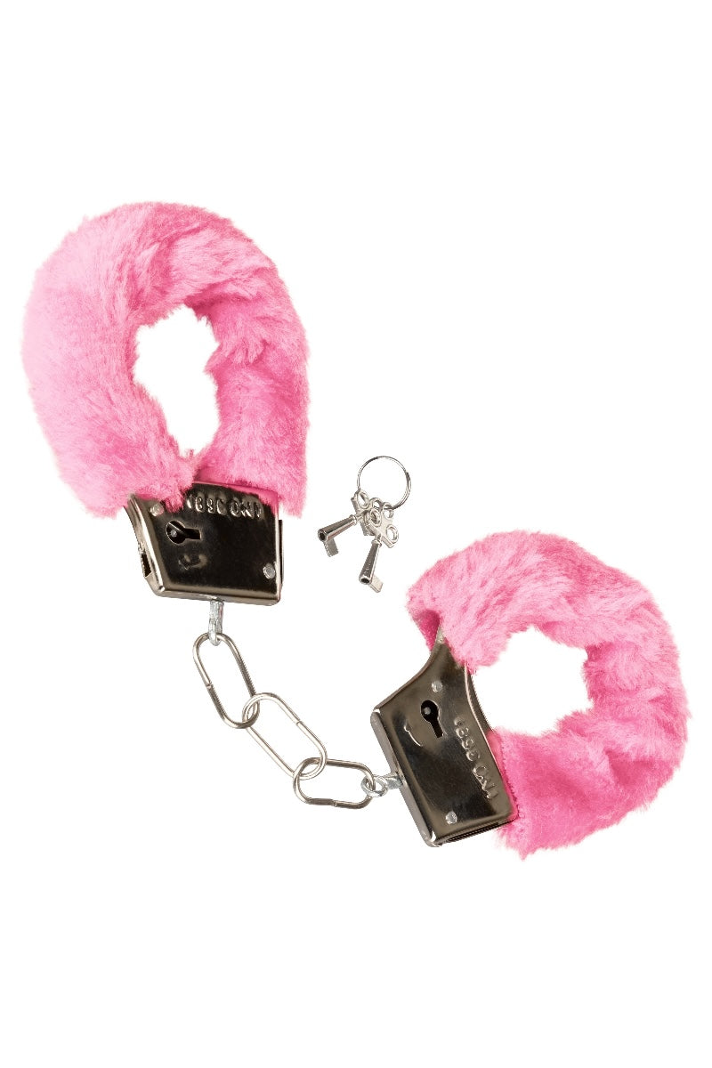 Pink fluffy handcuffs with a key on a white background