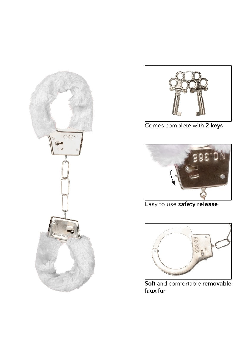 Handcuffs with faux fur covering and keys on a white background