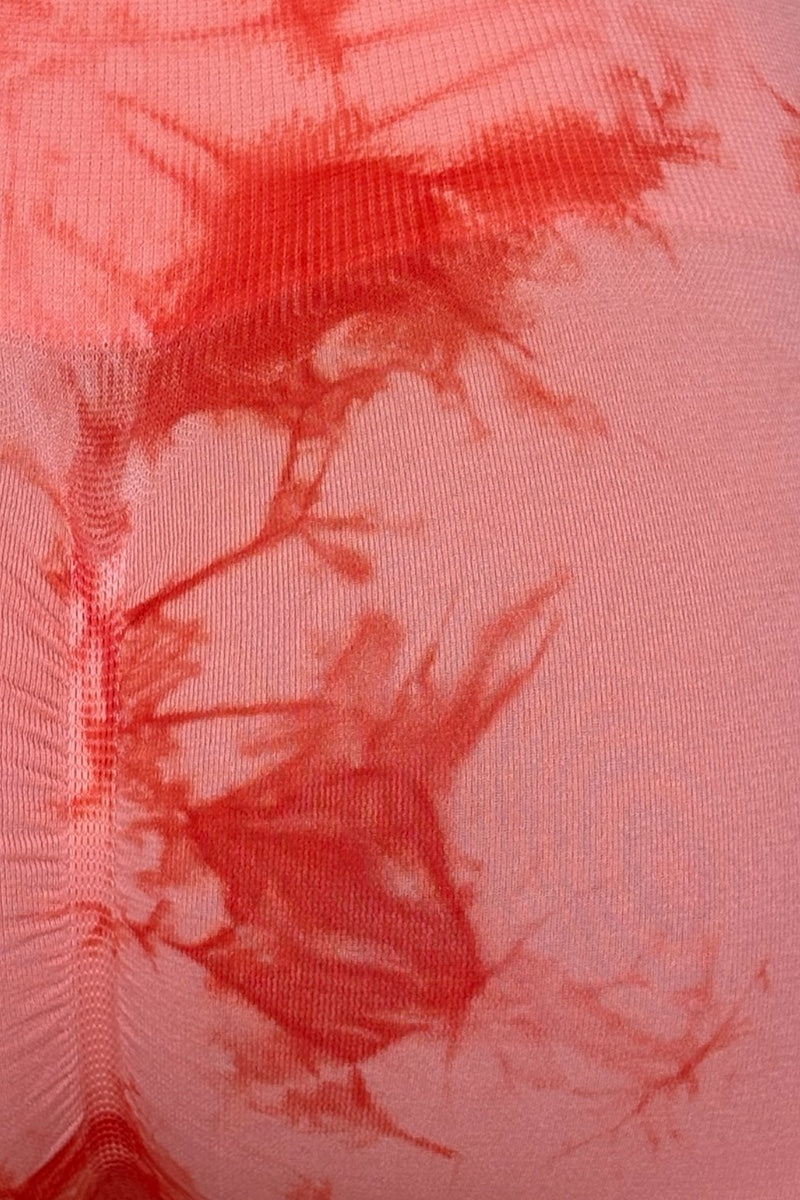 Close-up of an orange fabric with tie-dye pattern