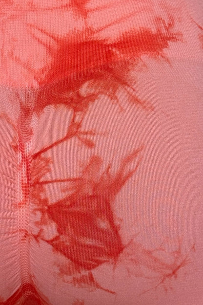 Close-up of an orange fabric with tie-dye pattern