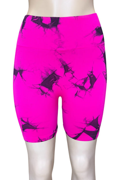 Bright pink athletic shorts with black abstract pattern on a white background