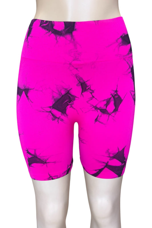 Bright pink athletic shorts with black abstract pattern on a white background