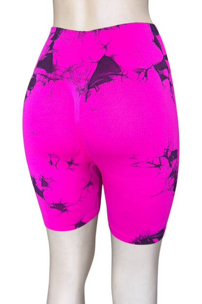 Pink athletic shorts with black abstract pattern on a white background