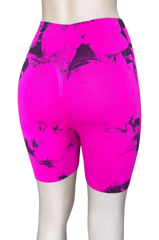 Pink athletic shorts with black abstract pattern on a white background