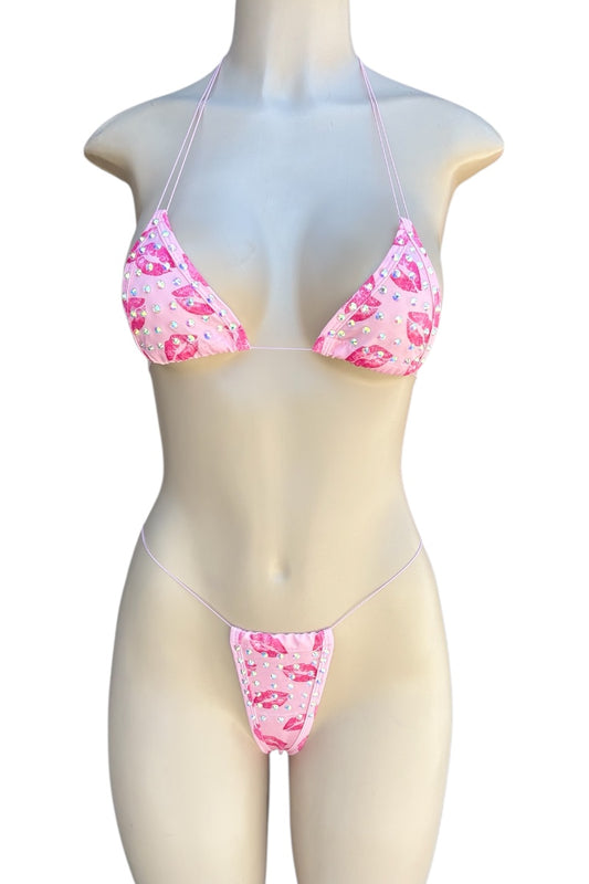 Pink kiss print bikini set on a mannequin against a white background