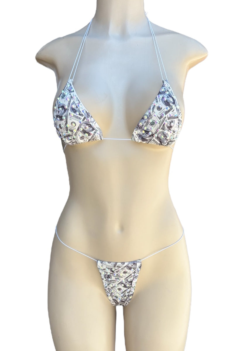 Bikini set with money print on a mannequin against a white background